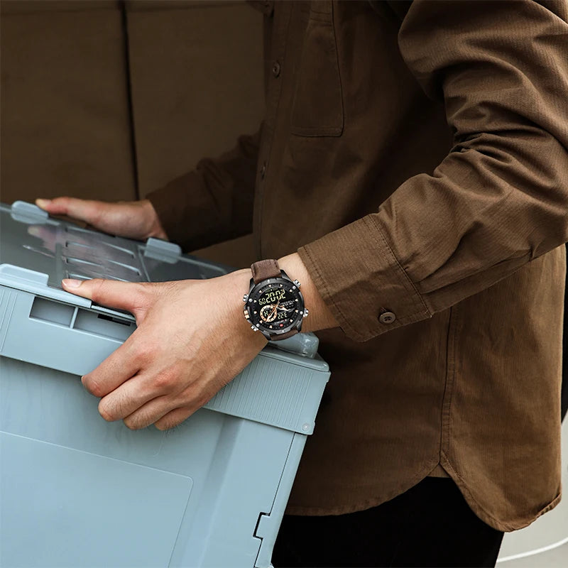Person wearing a brown shirt and watch holding a gray box.