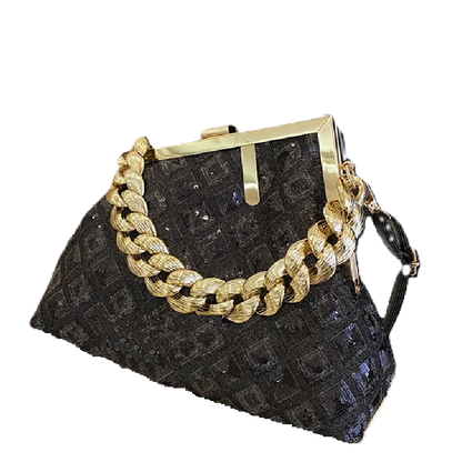 Black textured handbag with a gold chain detail on a white background