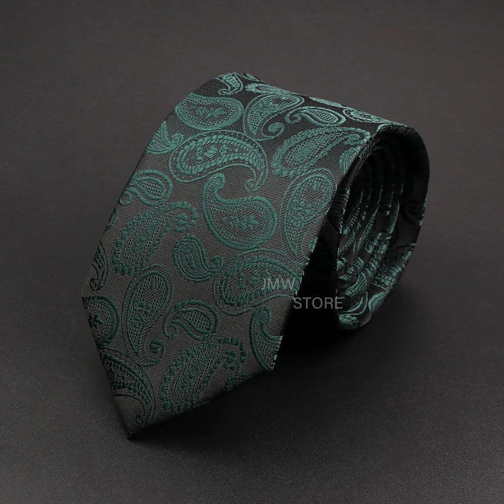 Green paisley patterned tie on a dark gray background