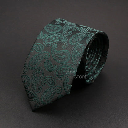 Green paisley patterned tie on a dark gray background