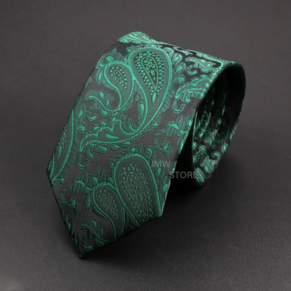 Green paisley patterned tie on a dark gray background