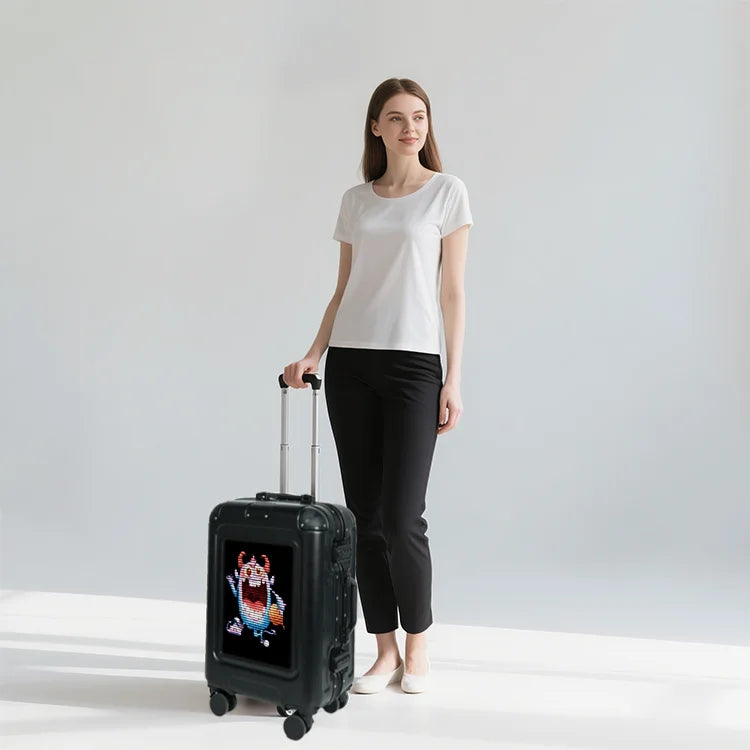 Woman standing with a black suitcase featuring a cartoon character on a light gray background