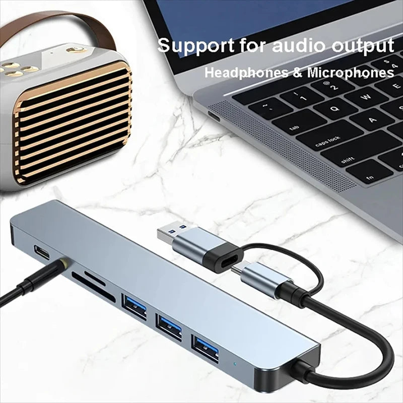 USB hub with multiple ports on a white surface with text about audio support.
